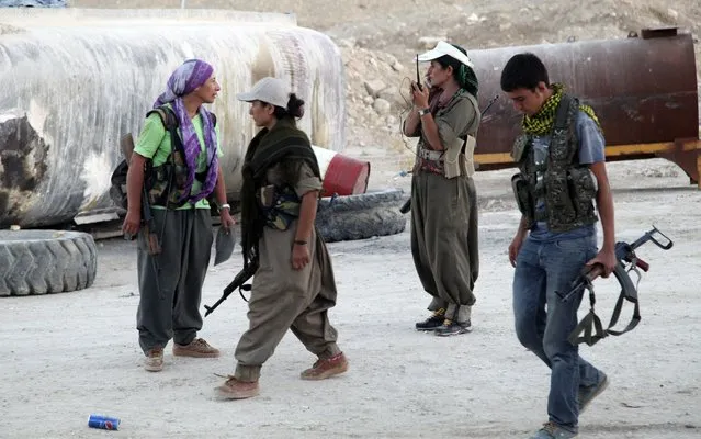 Kurdistan Workers Party (PKK) fighters participate in an intensive security deployment against Islamic State (IS) militants on the front line in Makhmur August 9, 2014. President Barack Obama said on Saturday U.S. airstrikes had destroyed arms that Islamic State militants could have used against Iraqi Kurds, but warned there was no quick fix to a crisis that threatens to tear Iraq apart. (Photo by Azad Lashkari/Reuters)