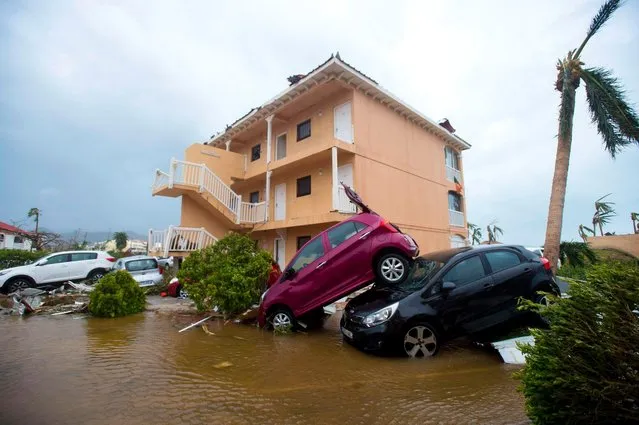 A photo taken on September 6, 2017 shows cars piled on top of one another in Marigot, near the Bay of Nettle, on the French Collectivity of Saint Martin, after the passage of Hurricane Irma France, the Netherlands and Britain on September 7 sent water, emergency rations and rescue teams to their stricken territories in the Caribbean hit by Hurricane Irma, which has killed at least 10 people. The worst- affected island so far is Saint Martin, which is divided between the Netherlands and France, where eight of the 10 confirmed deaths took place. (Photo by Lionel Chamoiseau/AFP Photo)