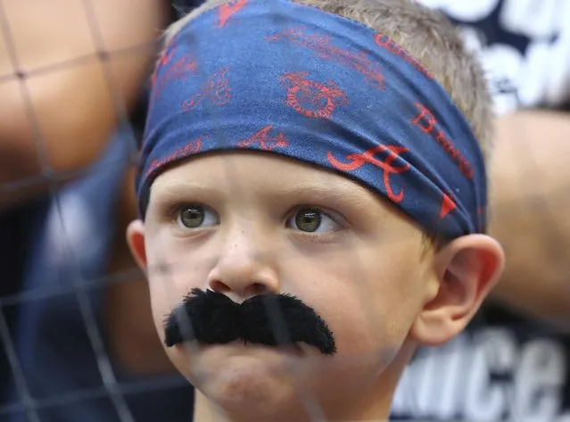 An Atlanta Braves baseball fan sports a moustache to show his support for the team’s pitcher Spencer Strider before his team took on the New York Mets in Atlanta, Georgia on July 13, 2022. (Photo by AP Photo)