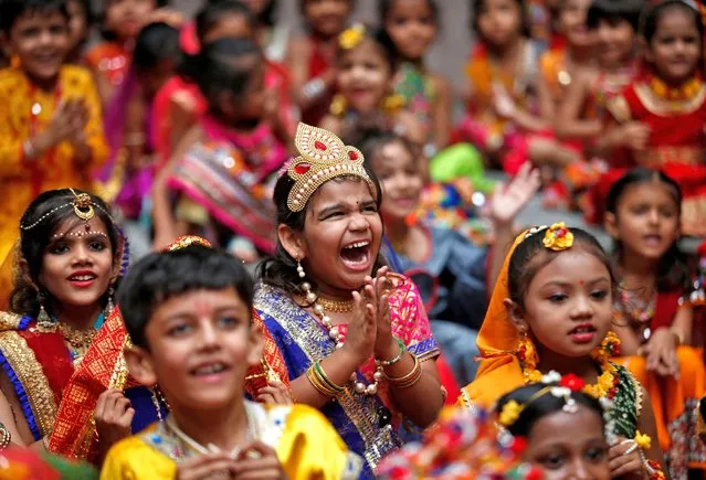 Children react as they celebrate Janmashtami festival, marking the birth anniversary of Hindu Lord Krishna, at a school in Ahmedabad, India on August 18, 2022. (Photo by Amit Dave/Reuters)