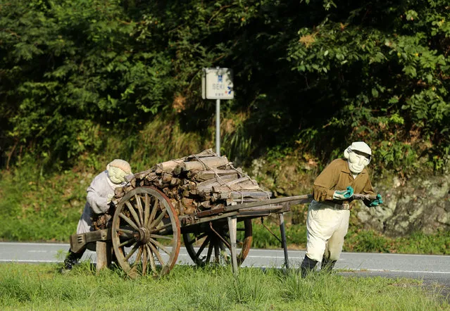 An illustration showing scarecrows pulling a firewood cart beside a road is on display at Kakashi no Sato, or the Scarecrow's Hometown on September 10, 2014 in Himeji, Japan. (Photo by Buddhika Weerasinghe/Getty Images)