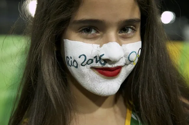 2016 Rio Olympics, Olympic Tennis Centre, Rio de Janeiro, Brazil on August 6, 2016. An 11-year-old Brazilian girl with face paint poses for a photo. (Photo by Kevin Lamarque/Reuters)