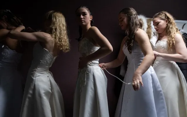 Participants prepare themselves before a Christmas Ball in Minsk, Belarus on December 23, 2019. (Photo by Vasily Fedosenko/Reuters)