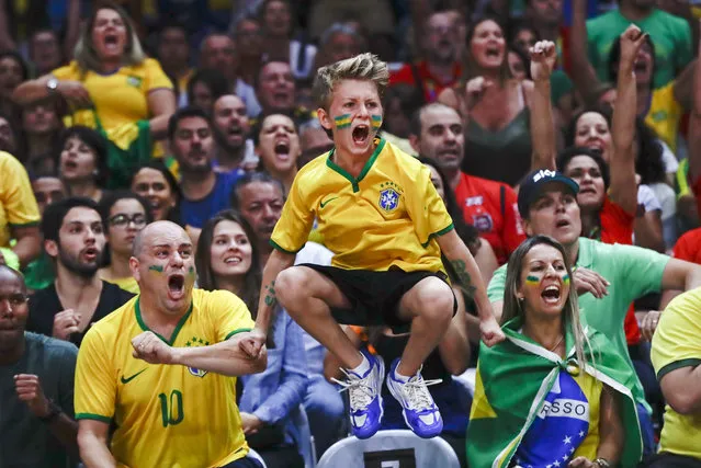 Fans of the Brazilian women's team cheer during a quarterfinal volleyball match against China at the 2016 Summer Olympics in Rio de Janeiro, Brazil, Tuesday, August 16, 2016. (Photo by Robert F. Bukaty/AP Photo)