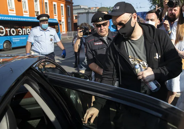 Russian film and theater director Kirill Serebrennikov, right, wearing a face mask to protect against coronavirus, leaves the Meshchansky court after hearings in Moscow, Russia, Friday, June 26, 2020. A Moscow judge convicted an acclaimed Russian theater director of embezzling state funds and imposed a three-year suspended sentence Friday in a case widely seen as politically motivated. (Photo by Pavel Golovkin/AP Photo)