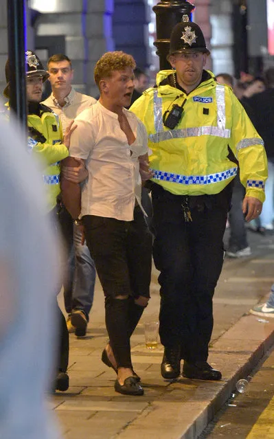 Police escorted one guy into the back of their van. Mayhem hits the streets of Newcastle, UK as clubbers out on the Toon have a little too much to drink as they enjoy the Bank Holiday on August 29, 2016. Photographs take last night show scantily-clad women passed out on the pavement, while boozed-up men were caught arguing with police. (Photo by XposurePhotos.com)
