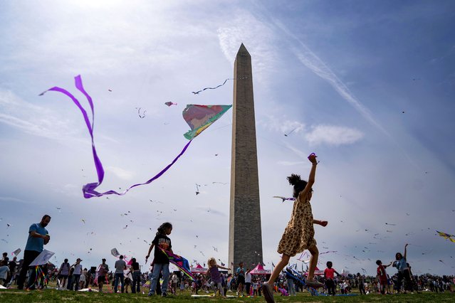 People fly kites during the Blossom Kite Festival, an event held as part of the National Cherry Blossom Festival, on the National Mall in Washington, DC on Saturday, March 29, 2025. Yesterday, the cherry blossoms hit peak bloom, which the National Park Services defines when 70% of Yoshino cherry blossoms have opened. (Photo by Bonnie Cash/UPI/Rex Features/Shutterstock)