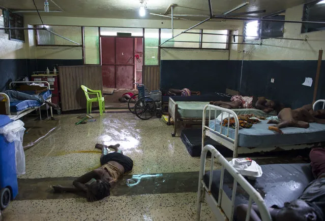 Two people lay dead on the floor inside the critical ward of the Redemption Hospital which has become a transfer and holding center to intake Ebola patients located in one of the poorest neighborhoods of Monrovia that locals call “New Kru Town” on Saturday September 20, 2014 in Monrovia, Liberia. (Photo by Michel du Cille/The Washington Post)