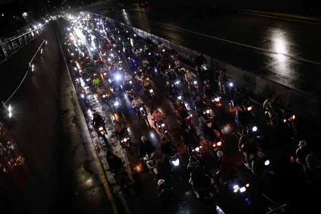 People participate in a motorcycle ride called “Caravan of Terror” to celebrate Halloween, in Caracas, Venezuela on October 29, 2022. (Photo by Leonardo Fernandez Viloria/Reuters)