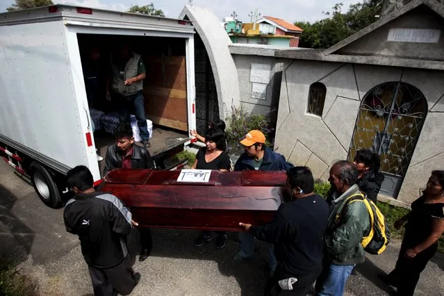Relatives participate in the burial of  a victim of a mudslide in Santa Catarina Pinula, on the outskirts of Guatemala City, October 6, 2015. Despair in the search for dozens of people still missing after a deadly landslide swallowed part of a Guatemalan town is so deep that some relatives feel lucky simply to have found the bodies of their loved ones. (Photo by Jose Cabezas/Reuters)