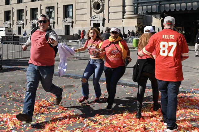 People flee after shots were fired near the Kansas City Chiefs' Super Bowl LVIII victory parade on February 14, 2024, in Kansas City, Missouri. A shooting incident at a packed parade Wednesday to celebrate the Kansas City Chiefs' Super Bowl victory killed one person and injured nine others, the city fire department said. (Photo by Andrew Caballero-Reynolds/AFP Photo)
