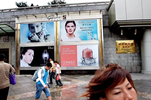 At the entrance to an underground walkway in Xi'an, pedestrians are greeted by ads for high-end perfumes, cosmetics and jewelry. (Photo by Mark Edelson/The Palm Beach Post)