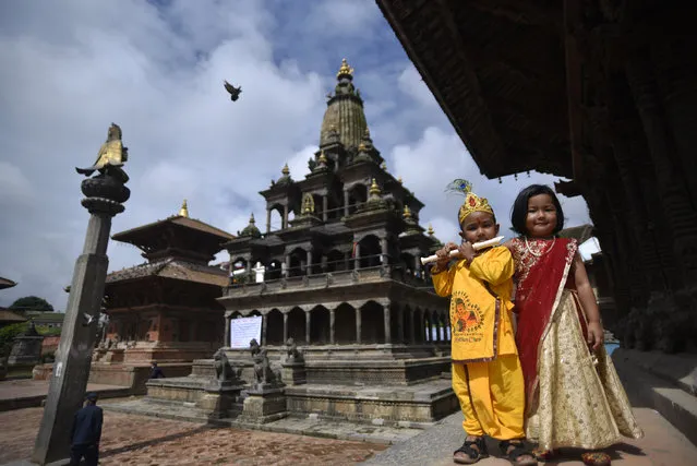 Kids dressed as the Hindu god Krishna and goddess Radha pose for photo during Krishna Janmashtami in Patan Durbar Square, Lalitpur, Nepal on Tuesday, August 11, 2020. Krishna Janmashtami festival marks the birthday of Hindu God Krishna, the eight incarnation of Lord Vishnu. Due to the on-going covid-19 pandemic entering inside the temple has been restricted. (Photo by Narayan Maharjan/NurPhoto via Getty Images)
