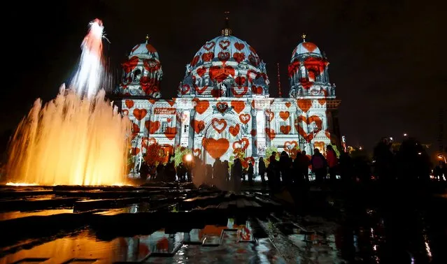 People look at a light installation at the Berlin Cathedral during the opening day of the "Festival of Light" show in Berlin, Germany, October 9, 2015. (Photo by Hannibal Hanschke/Reuters)