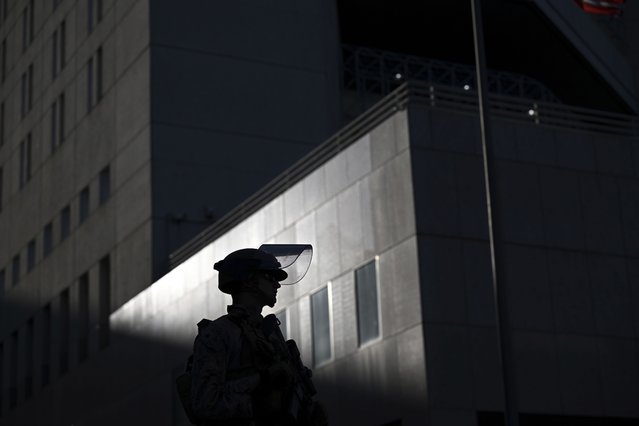 A U.S. Marine stands guard outside the downtown Metropolitan Detention Center Tuesday, June 17, 2025, in Los Angeles. (Photo by Wally Skalij/AP Photo)
