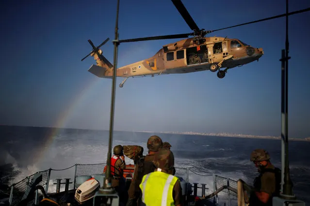 Israeli soldiers from the navy take part in a combined drill with a helicopter squadron, practicing the evacuation of a wounded person to land from a vessel in the Mediterranean Sea, off the coast of Ashdod, southern Israel September 19, 2016. (Photo by Amir Cohen/Reuters)