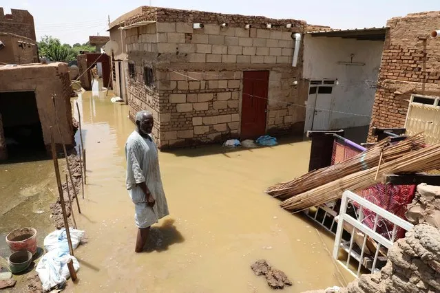 A man passes on the side of a flooded road in the town of Alkadro, about (20 km) north of the capital Khartoum, Sudan, Saturday, September 5, 2020. Sudanese authorities have declared their country a natural disaster area and imposed a three-month state of emergency across the country after rising floodwaters and heavy rainfall killed people and inundated over 100,000 houses since late July. (Photo by Marwan Ali/AP Photo)