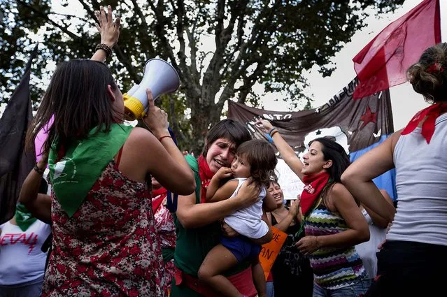 A woman hugs her daughter during a demonstration marking International Women's Day in Buenos Aires, Argentina. (Photo by Victor R. Caivano/Associated Press)