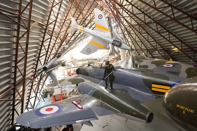 Specialists operators at the Royal Air Force Museum Midlands, in Cosford, near Telford, Shropshire, UK clean and maintain a suspended aircraft during the annual high-level aircraft cleaning within the museum's national Cold War exhibition on Tuesday, March 18, 2025. (Photo by Jacob King/PA Images via Getty Images)