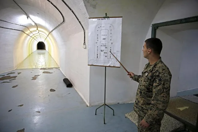 A member of the armed forces of Bosnia and Herzegovina shows a map of Josip Broz Tito's underground secret bunker (ARK) in Konjic, October 16, 2014. (Photo by Dado Ruvic/Reuters)