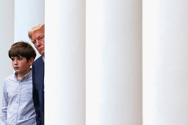 President Donald Trump, accompanied by his grandson Spencer Trump, looks after returning to the White House from Scotland, Britain, in Washington on July 29, 2025. (Photo by Umit Bektas/Reuters)