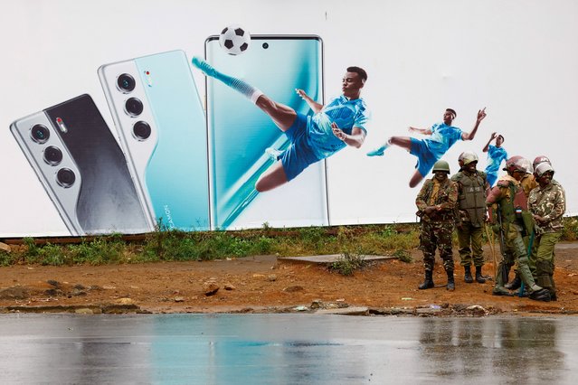 Administration Police Service officers in riot gear, gather near an advertisement, before “Saba Saba People's March” anti-government protests, in downtown Nairobi, Kenya on July 7, 2025. (Photo by Thomas Mukoya/Reuters)