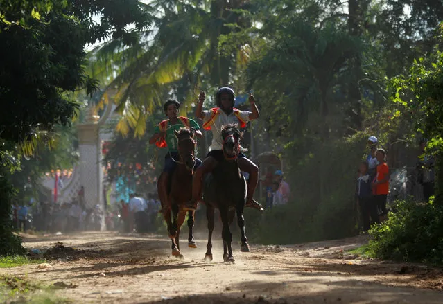 Men ride horses during the Pchum Ben festival, in Vihear Sour village in Kandal province, Cambodia, October 1, 2016. (Photo by Samrang Pring/Reuters)