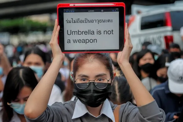 A young pro-democracy activist displays a message during a demonstration at Kaset intersection, suburbs of Bangkok, Thailand, Monday, October 19, 2020. Thai authorities worked Monday to stem a growing tide of protests calling for the prime minister to resign by threatening to censor news coverage, raiding a publishing house and attempting to block the Telegram messaging app used by demonstrators. (Photo by Sakchai Lalit/AP Photo)