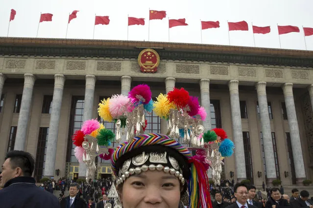 An ethnic minority delegate leaves from the Great Hall of the People on the eve of the annual legislature's opening session in Beijing, Sunday, March 4, 2018. (Photo by Ng Han Guan/AP Photo)