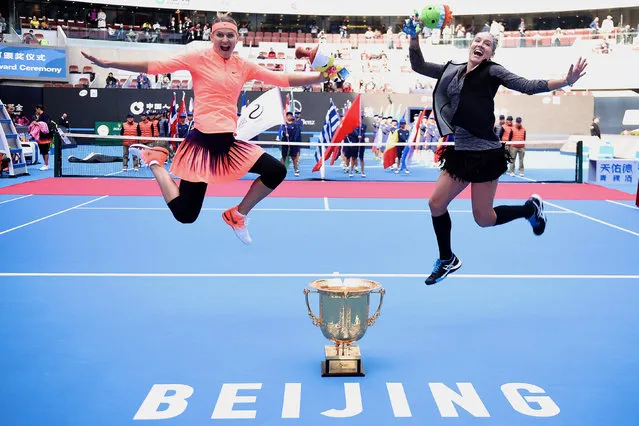 Tennis, China Open Women's double final, Beijing, China on October 9, 2016. Bethanie Mattek-Sands of the U.S. and Lucie Safarova of the Czech Republic jump to pose for photos as they hold their trophy after beating France's Caroline Garcia and Kristina Mladenovic. (Photo by Reuters/Stringer)