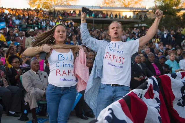 Demonstrators wearing shirts reading “Bill Clinton Rapist” protest as US President Barack Obama speaks during a Hillary for America campaign event in Greensboro, North Carolina, October 11, 2016. (Photo by Jim Watson/AFP Photo)