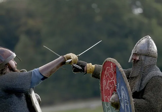 Re-enactors participate in a demonstration before a re-enactment of the the Battle of Hastings on the 950th anniversary of the battle, in Battle, Britain October 15, 2016. (Photo by Neil Hall/Reuters)