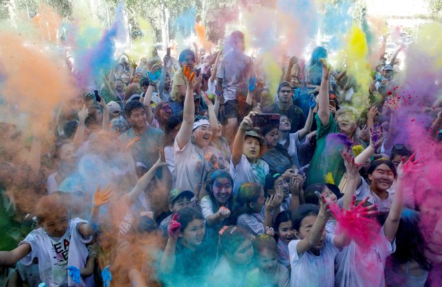 People daubed with powders take part in the Festival of Colours in Bishkek, Kyrgyzstan on June 1, 2024. (Photo by Vladimir Pirogov/Reuters)
