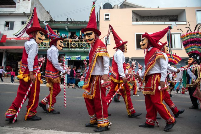 Traditional dancers known as Dancers of Conquest perform their routine during the traditional “Solemnity of Saints Peter and Paul Celebration” on June 29, 2024 in Veracruz, Mexico. Every year, thousands of people from Chiconquiaco and nearby communities attend the celebration of apostles St. Peter and St. Paul, to take the streets with dances and processions. During the day, parents take their children to be part of a particular ritual in which a priest puts a key inside the children's mouth. It is said that the ritual will help them to talk faster or better. (Photo by Hector Quintanar/Getty Images)