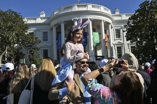 Chip and Stefanie Fletcher and their daughter Maddie, 6, of Tampa Bay, Fla., take family photos as they wait for President Joe Biden and First Lady Jill Biden along with the Easter Bunnies to make an appearance during the 2023 White House Easter Egg Roll at the White House on April 10, 2023 in Washington, D.C. (Photo by Ricky Carioti/The Washington Post)