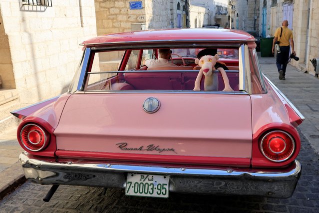 Palestinians drive classic cars during a gathering organized by the Bethlehem municipality near the Church of the Nativity in Manger Square in Bethlehem in the Israeli-occupied West Bank, on October 17, 2025. (Photo by Mussa Qawasma/Reuters)