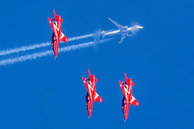 The picture dated February 8, 2023 shows the iconic Red Arrows nose diving in front of a Lufthansa A350 bound for Munich on February 8, 2023. The planes were spotted making the most of the sunny weather and blue skies to practise their twists and turns over RAF Scampton in Lincolnshire. (Photo by Martyn Foss/Bav Media)