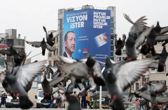 Pigeons fly in front of a large election poster of Turkish President Tayyip Erdogan in Istanbul,Turkey, June 22, 2018. (Photo by Goran Tomasevic/Reuters)