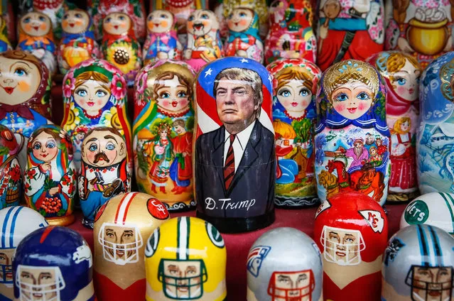 A matryoshka doll with the face of US President-elect Donald Trump surrounded by other matryoshkas is displayed on the table of the street souvenir vendor in the Andriyivskyy Descent in downtown Kiev, Ukraine, 10 November 2016. Americans on 08 November chose Republican candidate Donald Trump as the 45th President of the United States of America, to serve from 2017 through 2020. (Photo by Roman Pilipey/EPA)
