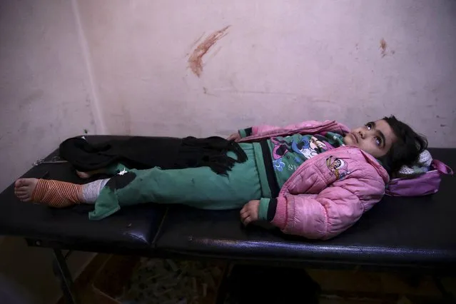 An injured student rests inside a field hospital after what activists said were air and missile strikes in the Douma neighborhood of Damascus, Syria December 13, 2015. (Photo by Bassam Khabieh/Reuters)