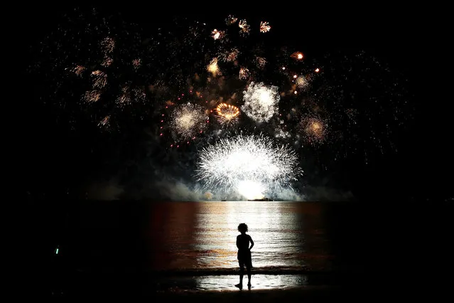 A young girl watches the fireworks display during Territory Day celebrations at Mindil Beach on July 1, 2018 in Darwin, Australia. Every year on July 1, Northern Territorians celebrate self-governance. It is the only day of the year pyrotechnics are allowed to be sold to the public, with locals allowed to set off fireworks between 6pm and 11pm. The only restriction is that fireworks must not be used at Territory Day community events, and the noise they emit must not exceed 115 decibels. (Photo by Mark Kolbe/Getty Images)
