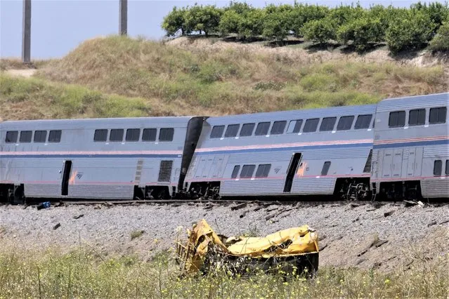 A destroyed truck lies near a derailed Amtrak train in Moorpark, Calif., on Wednesday, June 28, 2023. Authorities say the Amtrak passenger train carrying 190 passengers derailed after striking a vehicle on tracks in Southern California. Only minor injuries were reported. (Photo by Dean Musgrove/The Orange County Register via AP Photo)