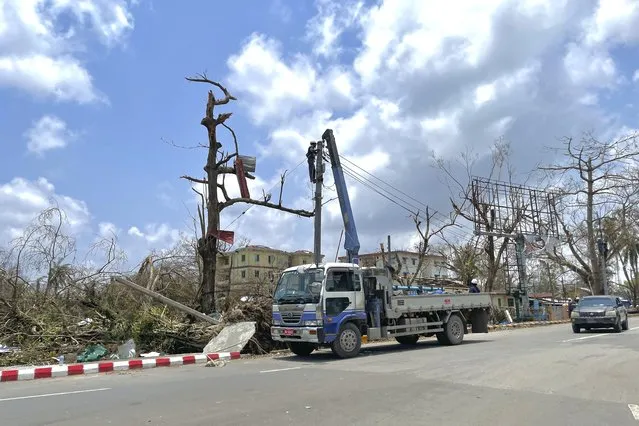 Electrical staff rebuilt lamp-posts damaged by Cyclone Mocha in Sittwe township, Rakhine State, Myanmar, Friday, May 19, 2023. (Photo by AP Photo/Stringer)