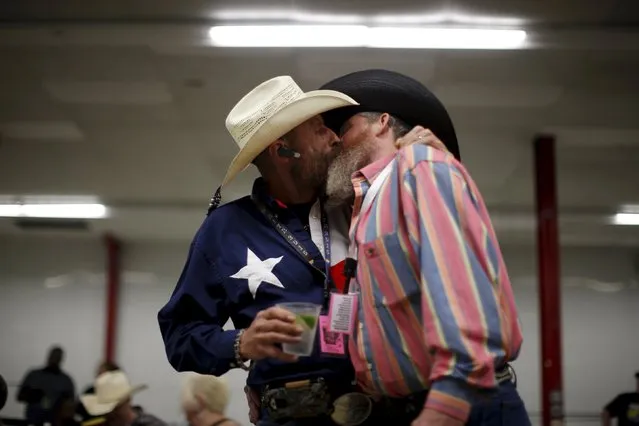Gordon Satterly, 61, from Michigan (L) kisses his husband Richard Brand, 53, from Texas, at the International Gay Rodeo Association's Rodeo In the Rock party in Little Rock, Arkansas, United States April 24, 2015. (Photo by Lucy Nicholson/Reuters)