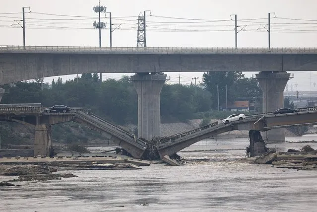 A bridge is damaged after remnants of Typhoon Doksuri brought rains and floods in Beijing, China on August 2, 2023. (Photo by Tingshu Wang/Reuters)