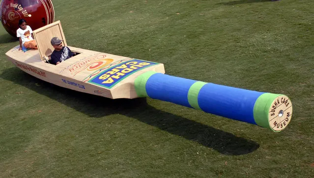 Sudhakar Yadav, an Indian rides a cricket bat shaped car in the southern Indian city of Hyderabad March 10, 2007. A 25 feet long cricket bat shaped car is to support team India in the world cup cricket, Yadav said. (Photo by Krishnendu Halder/Reuters)