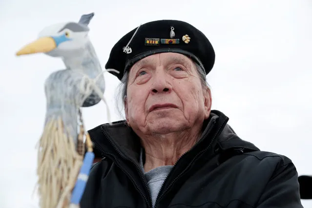 Korean War veteran George Martin, 80, an Ojibwe tribe from Hopkins, Michigan, stands with veterans who oppose the Dakota Access oil pipeline on Backwater Bridge near Cannon Ball, North Dakota, U.S., December 2, 2016. (Photo by Terray Sylvester/Reuters)