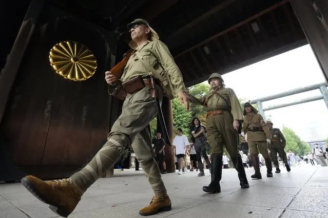 Visitors in Japanese Imperial army costume enter the Yasukuni Shrine, which honors Japan's war dead, Tuesday, August 15, 2023, in Tokyo, Japan. Japan holds annual memorial service for the war dead as the country marks the 78th anniversary of its defeat in the World War II. (Photo by Eugene Hoshiko/AP Photo)