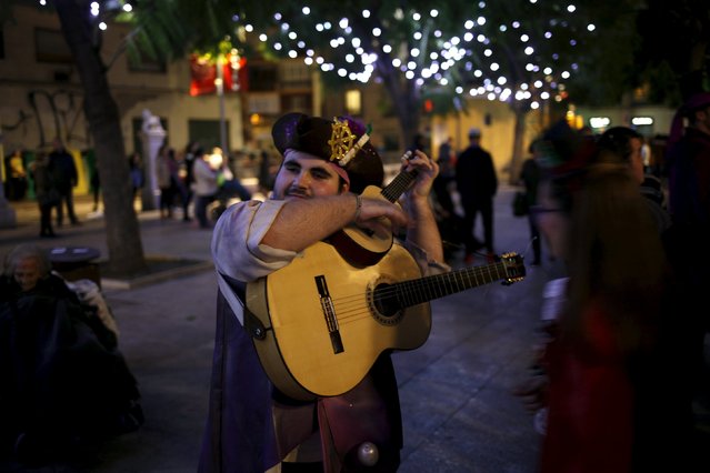 A reveller dressed as a pirate tunes a guitar as he takes part in a parade during the Carnival of Malaga, southern Spain, January 31, 2016. (Photo by Jon Nazca/Reuters)