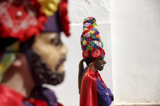 Penitents wear their village's traditional Judea mask and colorful hats during the Calvario procession by the “Nuestro Padre Jesus Nazareno and Nuestra Seóora de la Piedad” brotherhood in Iznajar, Spain, Friday, April 3, 2015. (Photo by Daniel Ochoa de Olza/AP Photo)